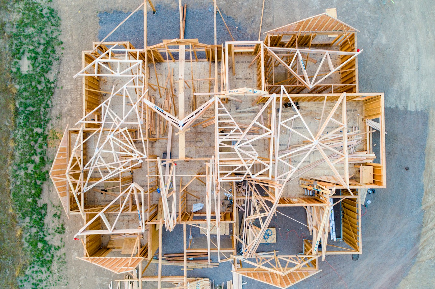 Aerial view of a house frame and site under construction