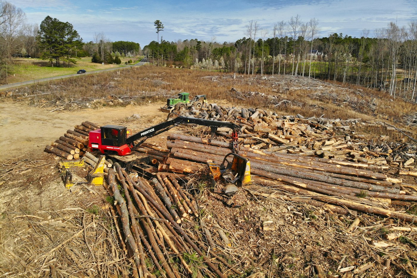 Aerial view of a logging and land clearing site with equipment